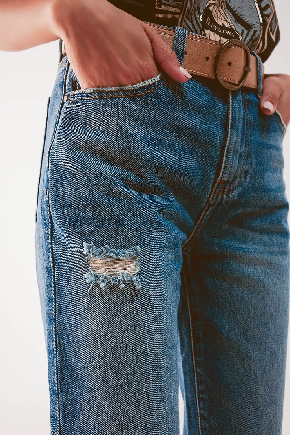 Jeans a vita alta con strappo in blu medio