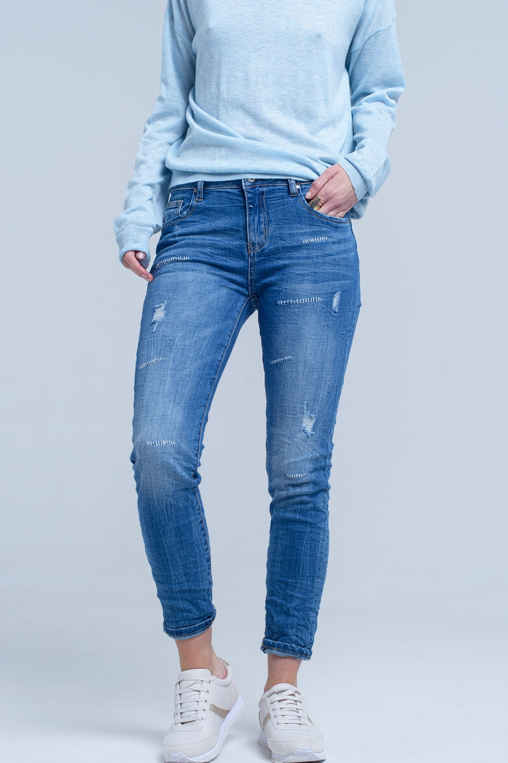 Jeans alla caviglia con strappo e riparazione