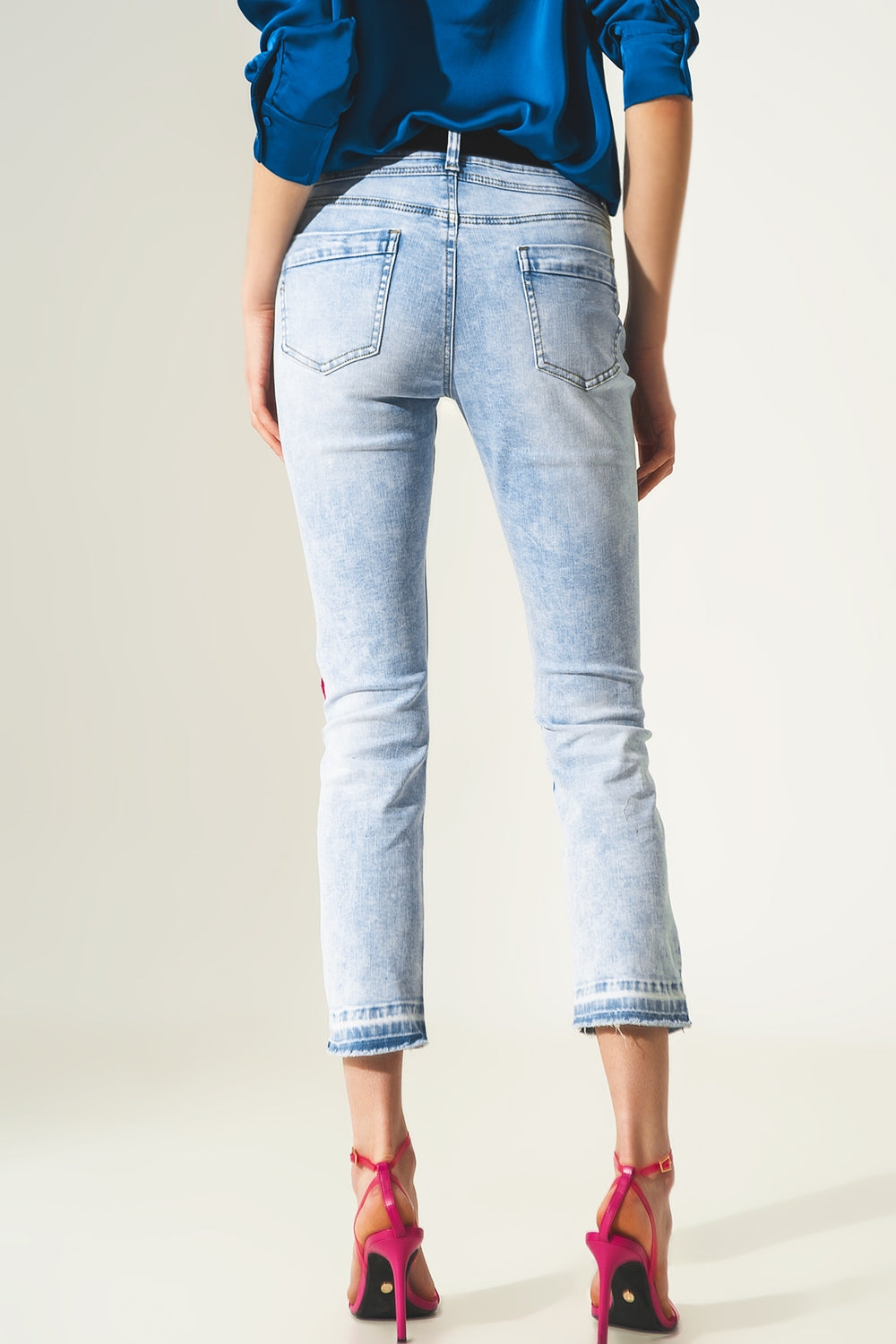Jeans dritti strappati con dettaglio sull'orlo in blu