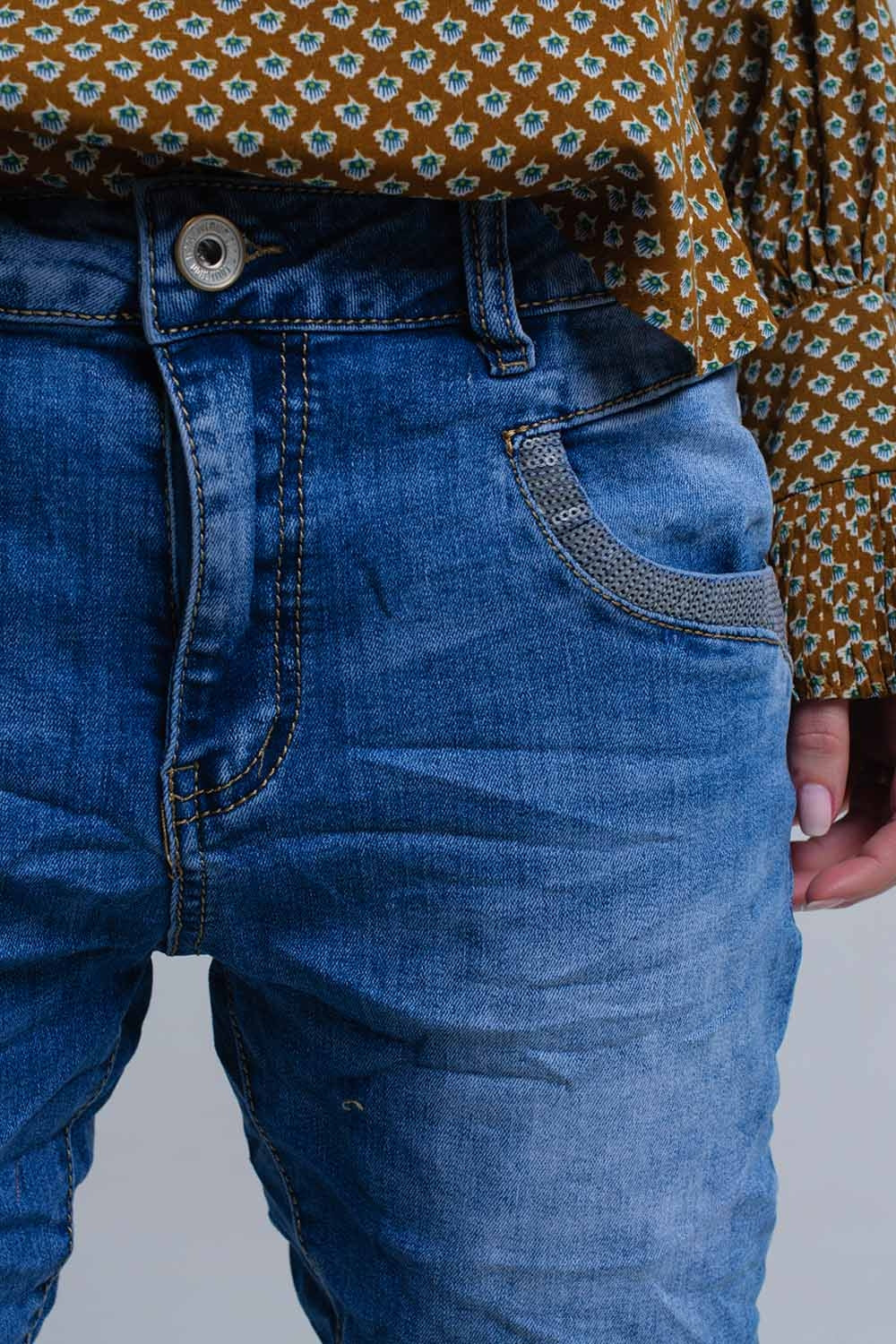Jeans skinny blu con dettagli in paillettes