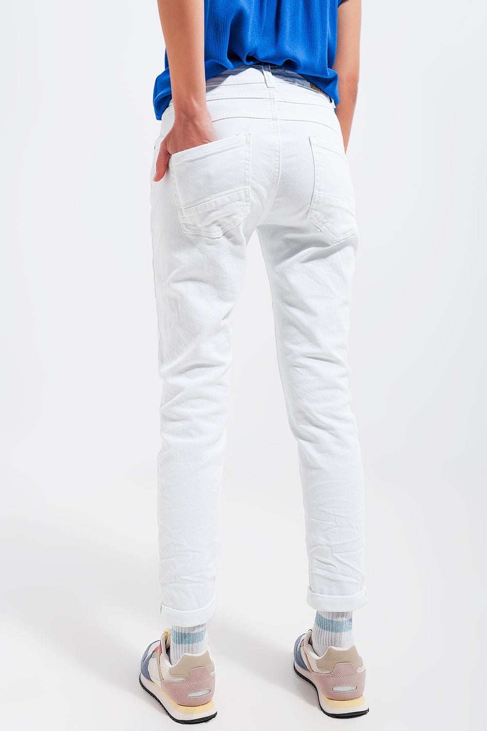 Jeans skinny con bottoni a vista e lavaggio bianco