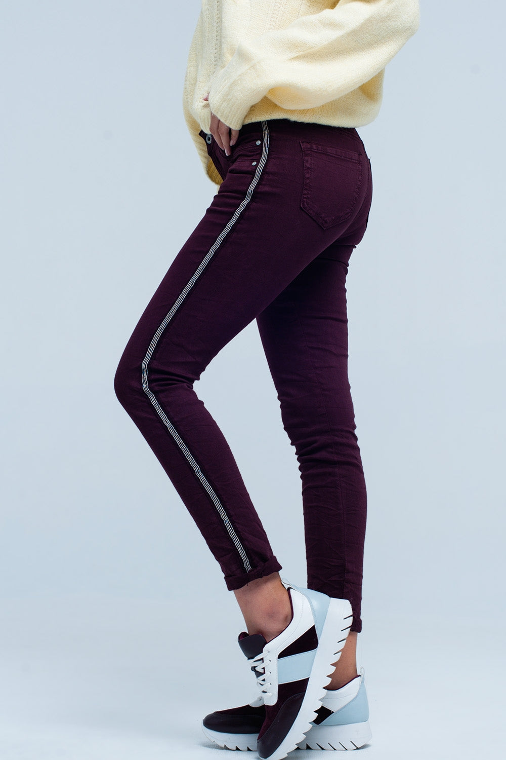 Jeans skinny con riga laterale metallizzata
