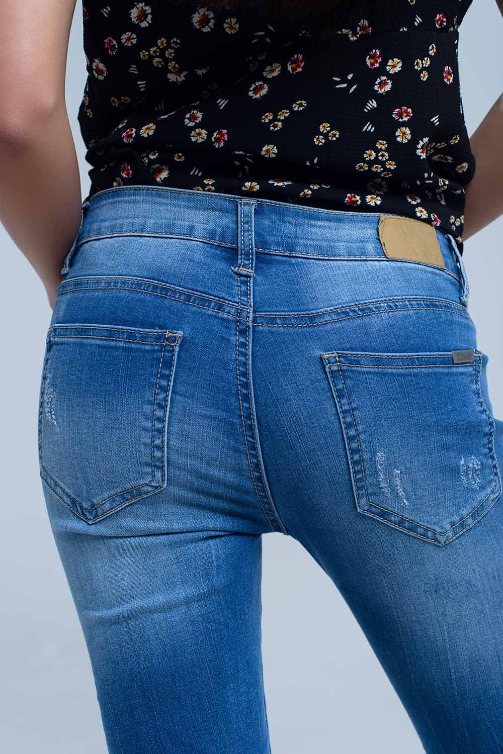 Jeans skinny con strappi al ginocchio