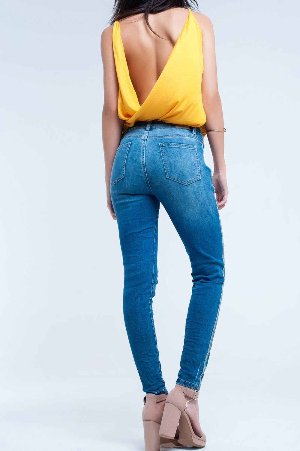 Jeans skinny con strappi e glitter