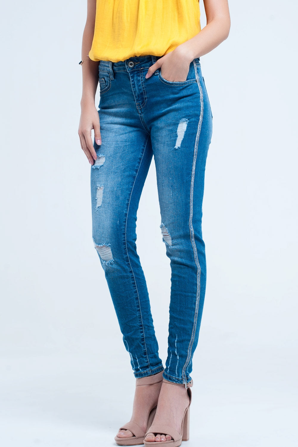Jeans skinny con strappi e glitter