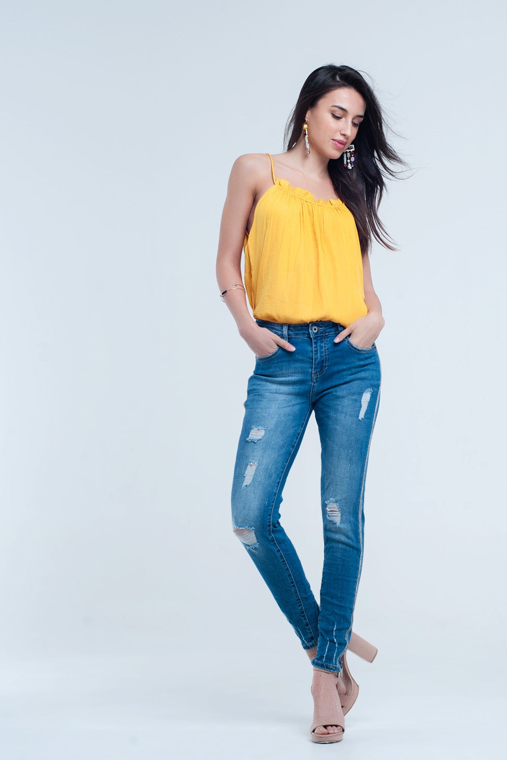 Jeans skinny con strappi e glitter