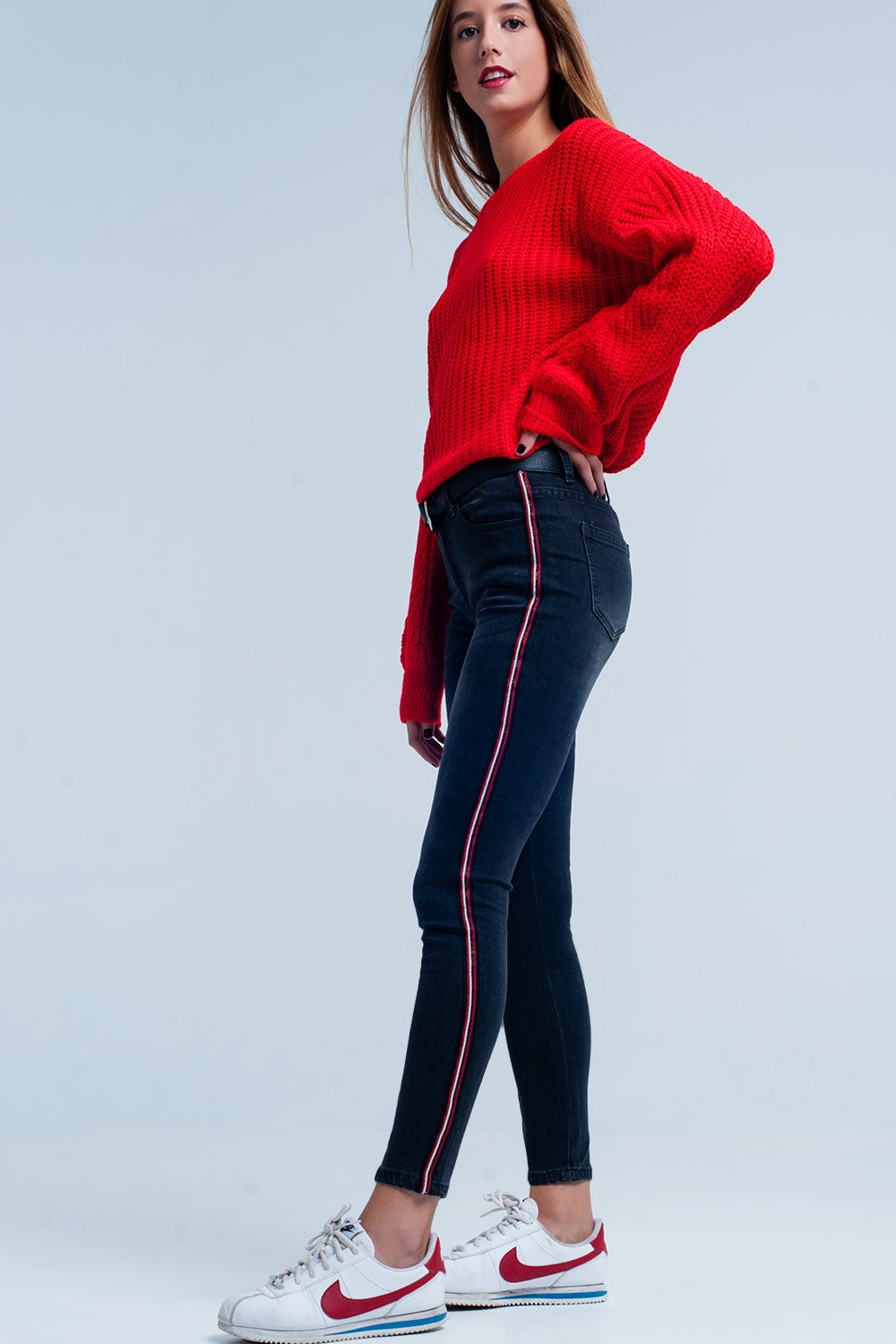 Jeans skinny neri con banda laterale rosso