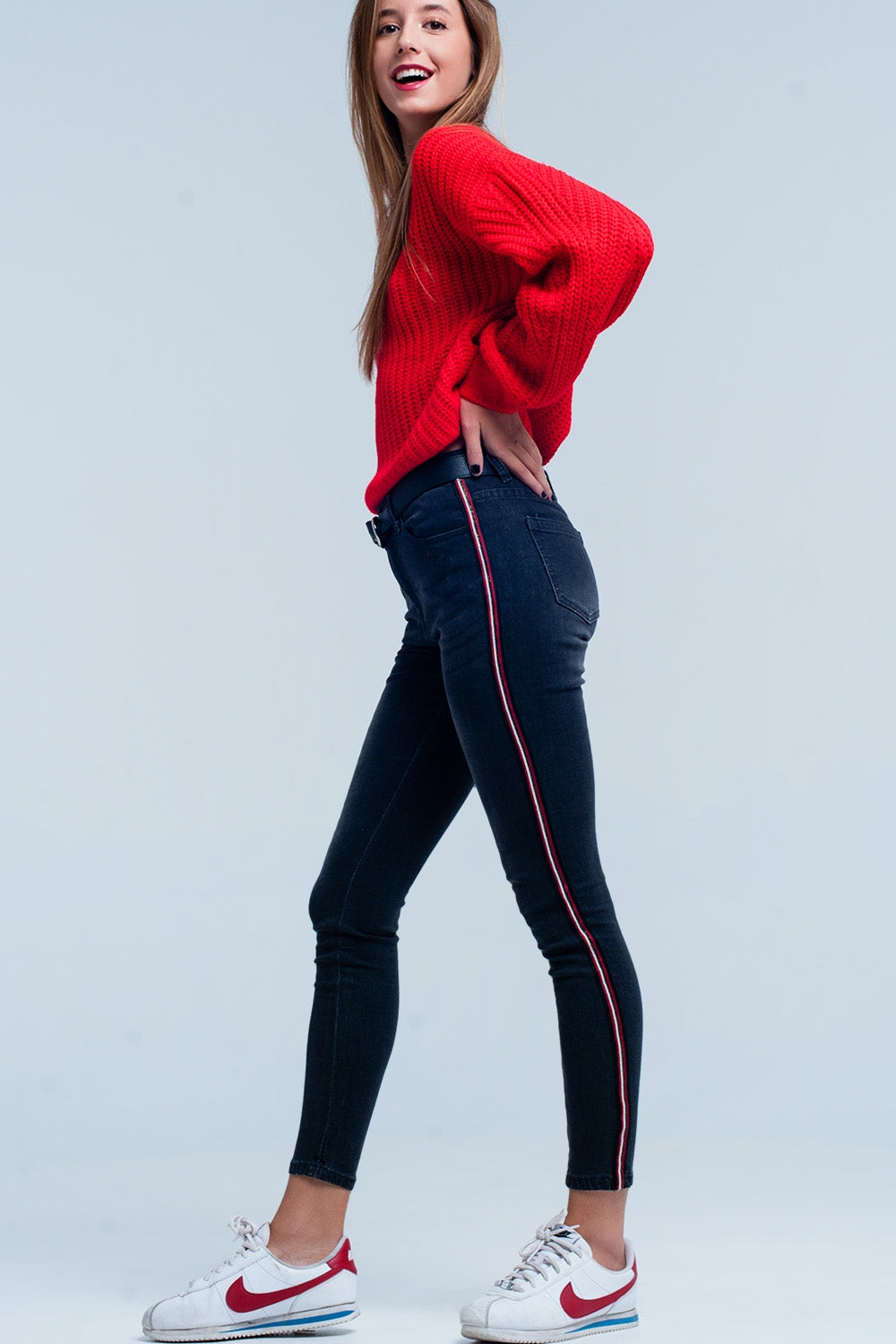 Jeans skinny neri con banda laterale rosso