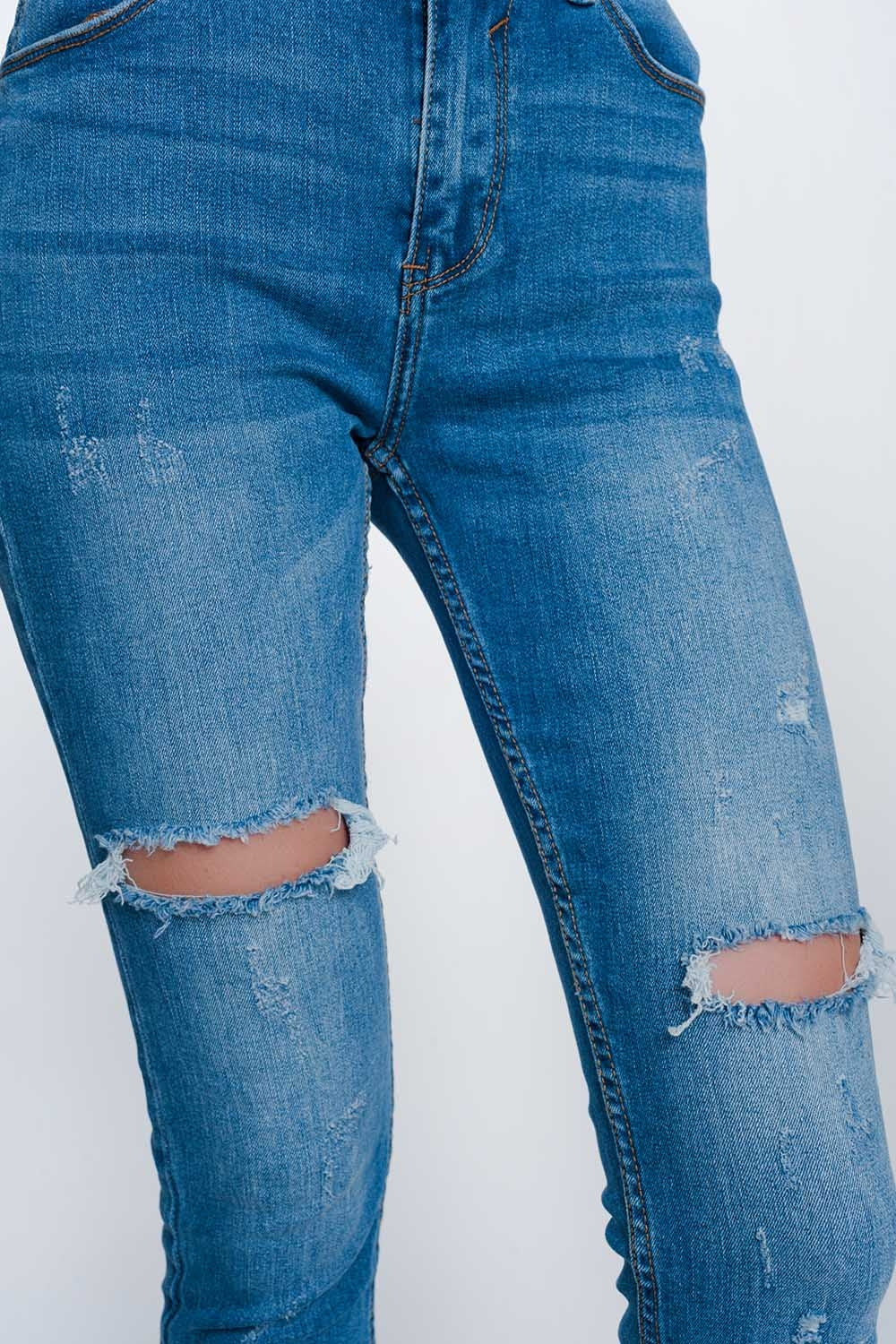 jeans super skinny con fori nelle ginocchia