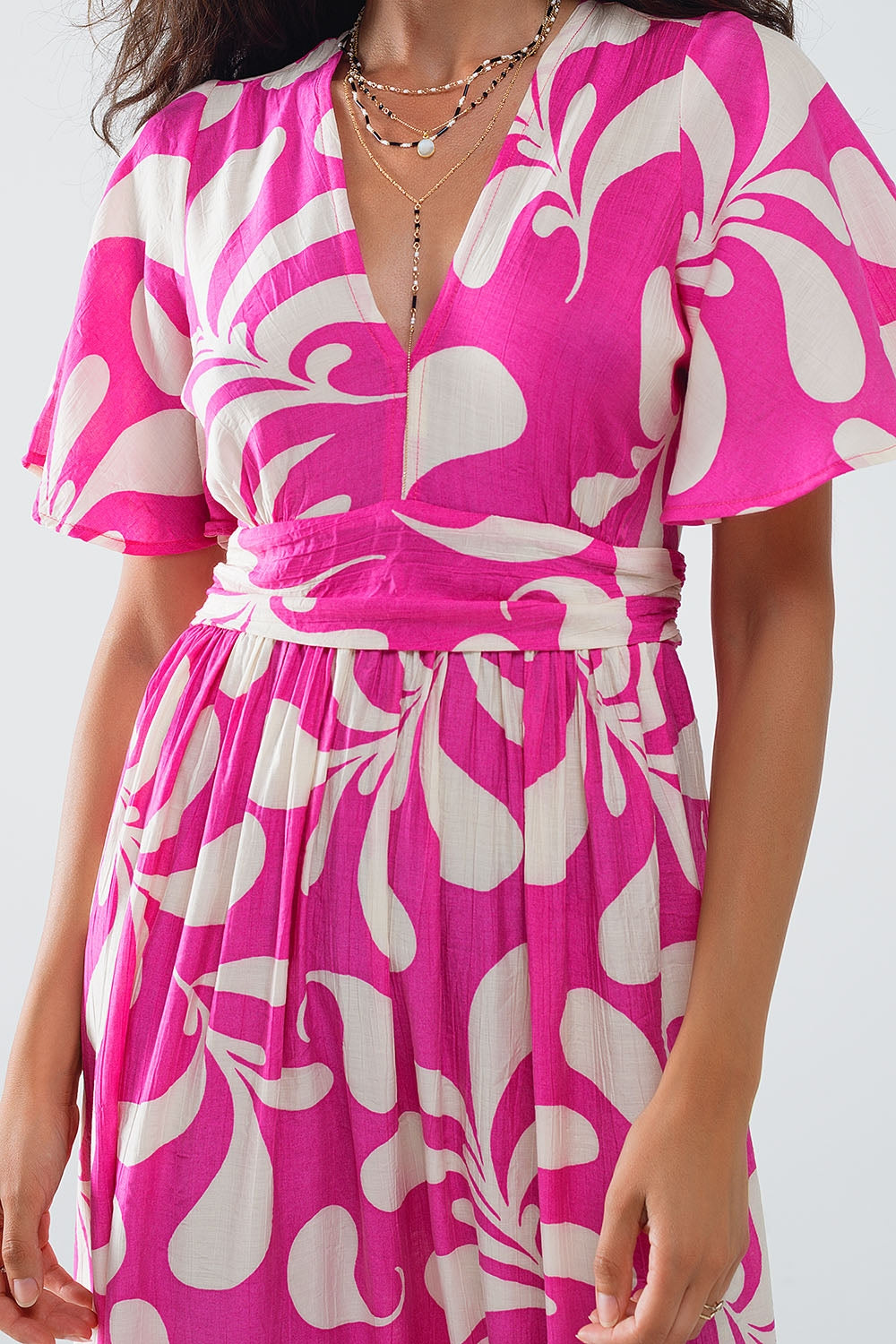 Maxi abito con stampa floreale fucsia e schiena scoperta