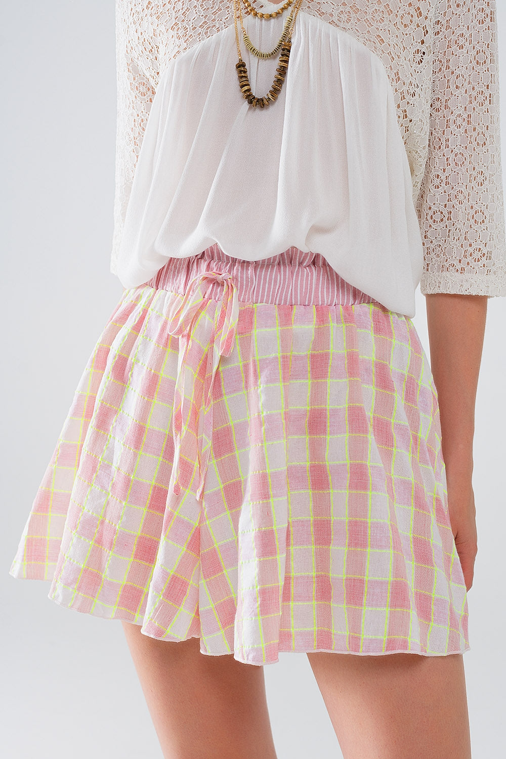 Pantaloncini con stampa a scacchi rosa e dettagli aderenti in vita