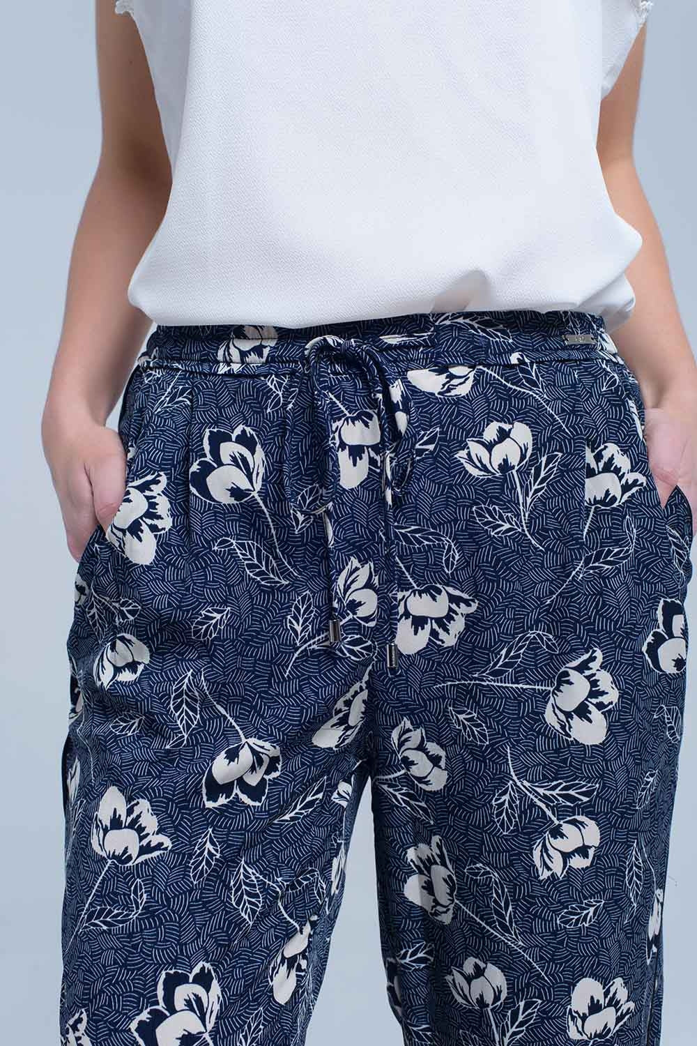 Pantaloni blu navy con stampa floreale