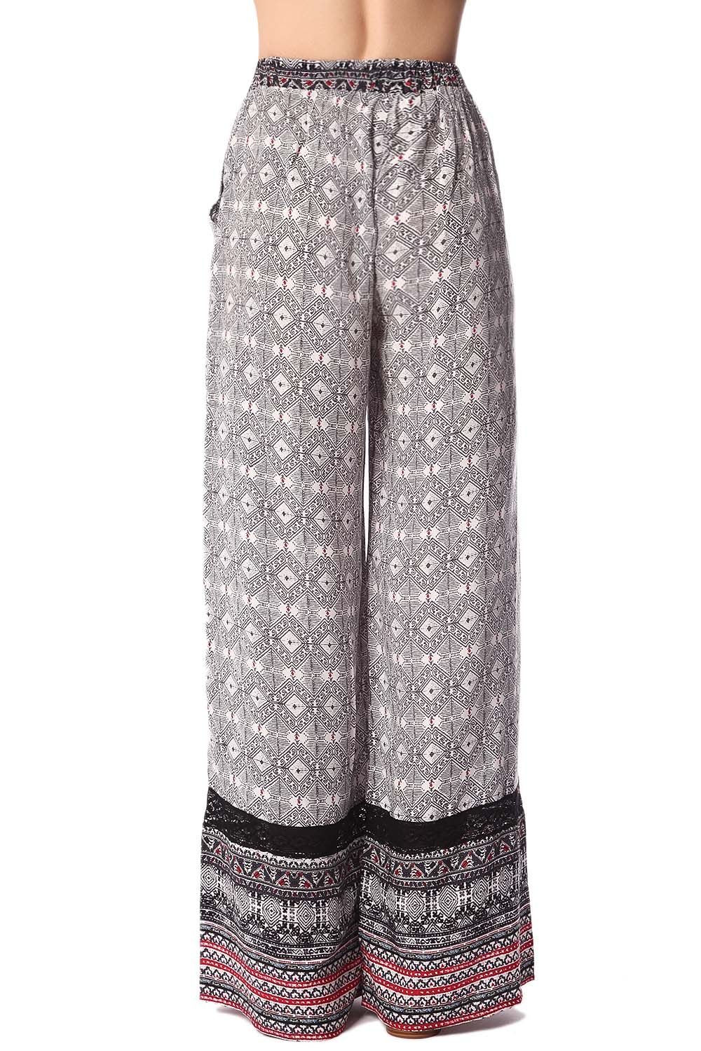 Pantaloni con fondo ampio nero con stampa etnica e inserto in pizzo