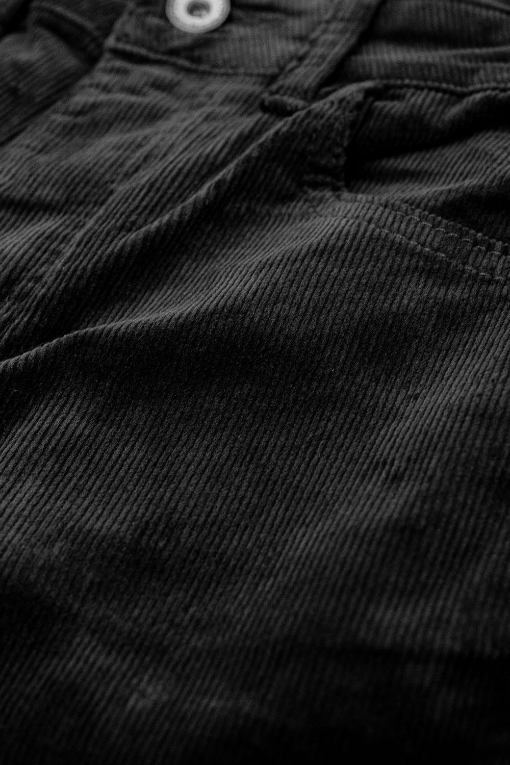 Pantaloni flare in velluto a coste nero con stampa leopardata sul fondo