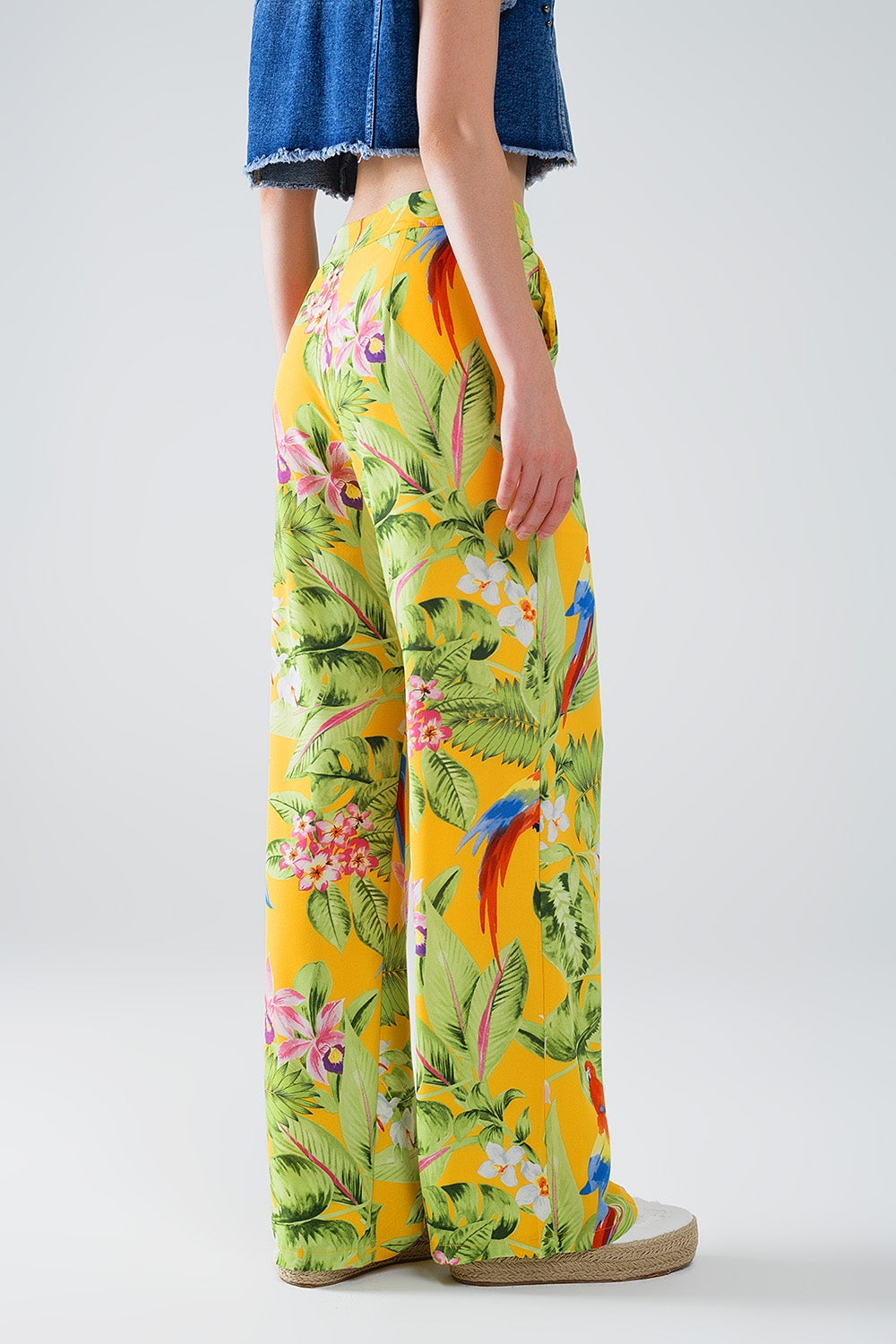Pantaloni gialli con stampa tropicale e zip laterale