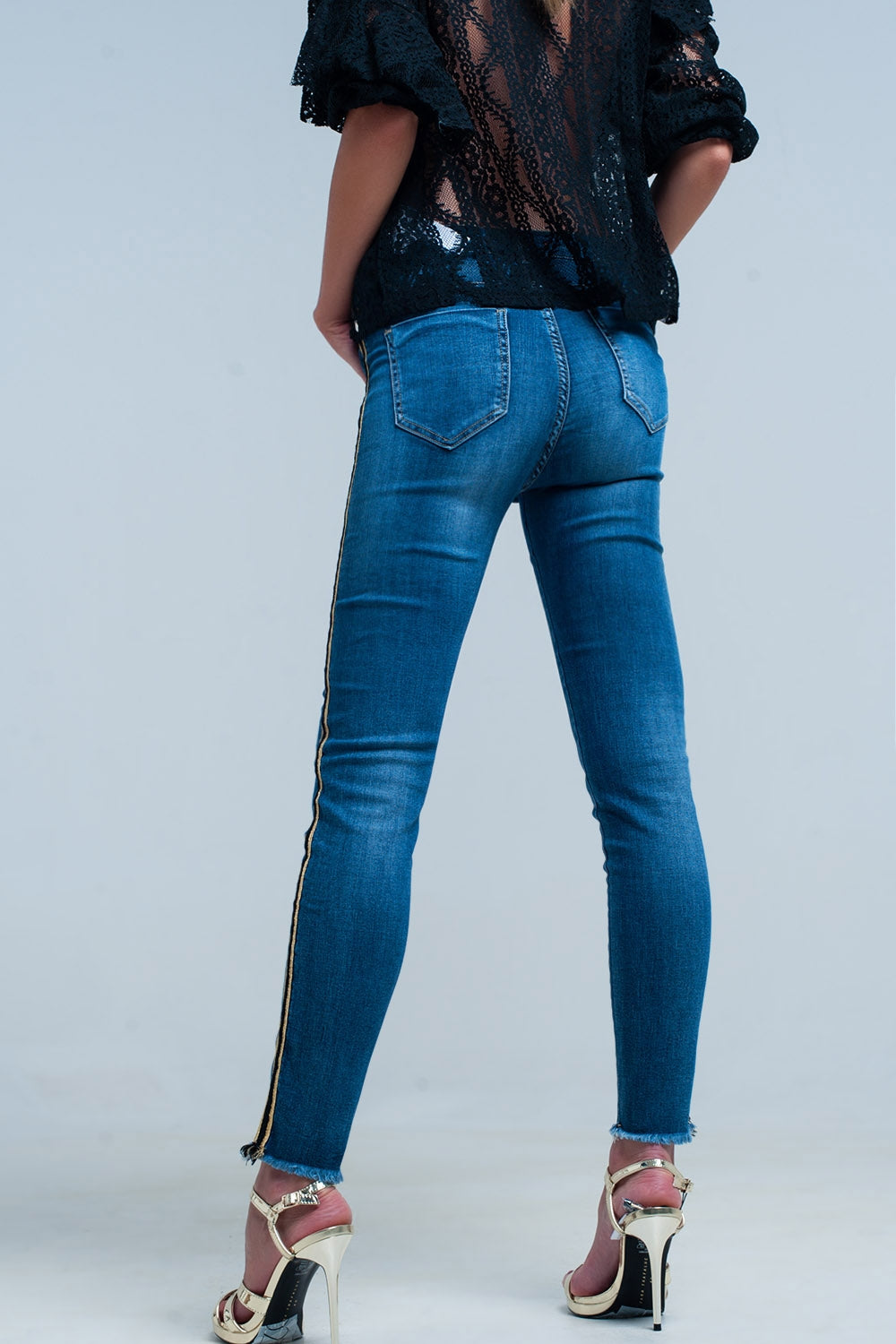 Pantaloni in denim blu con fascia laterale dorata e nera