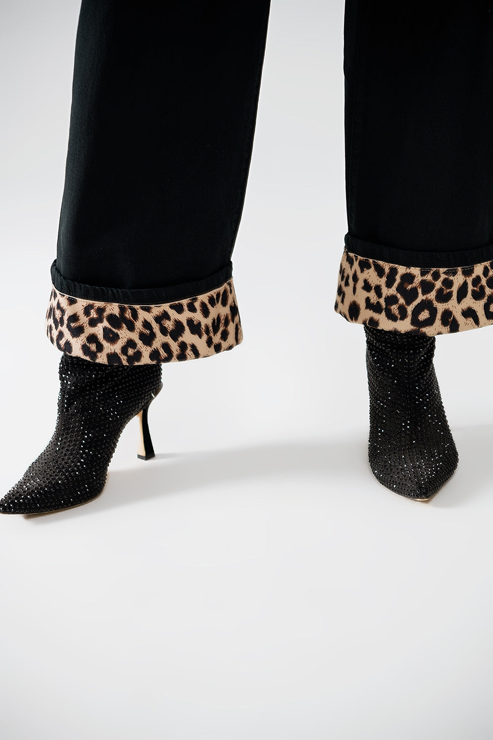 Pantaloni neri a gamba larga con stampa leopardata sul fondo