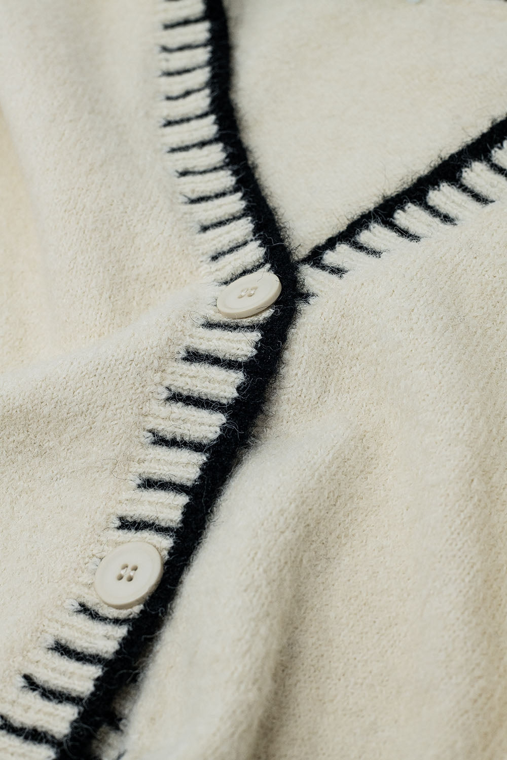 Cardigan crema con finiture nere