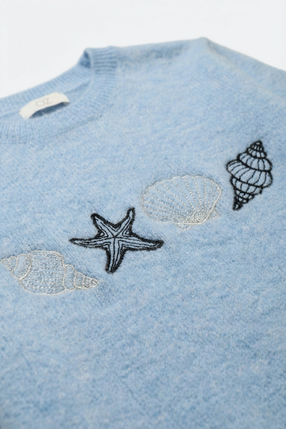Maglione a maniche corte in maglia azzurra conchiglia