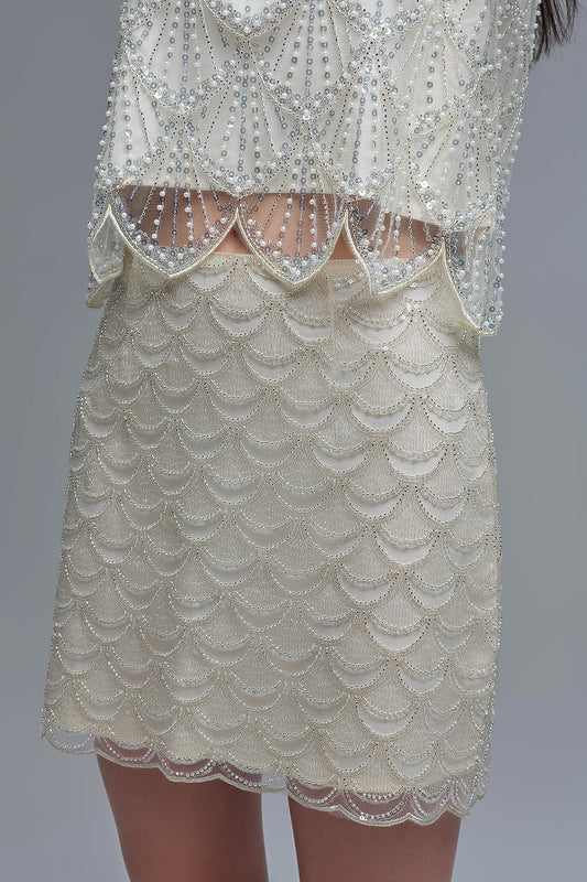 Minigonna smerlata in paillettes color crema