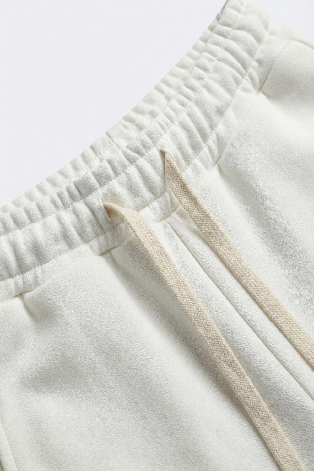 Pantaloni da ginnastica dritti in maglia panna con elastico in vita e cravatta