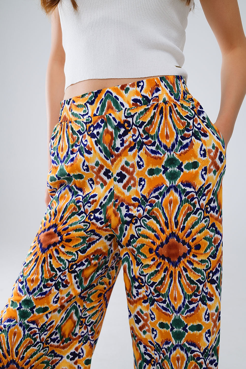 Pantaloni multicolore con stampa floreale in arancione e blu