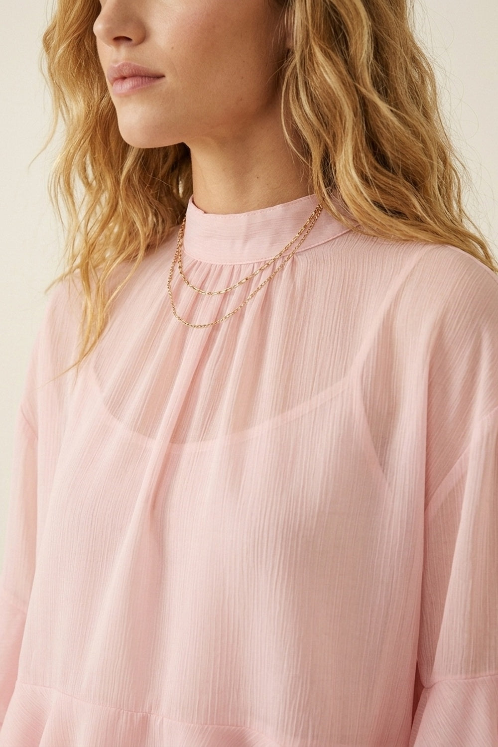 Top asimmetrico a collo alto con volant in chiffon rosa chiaro