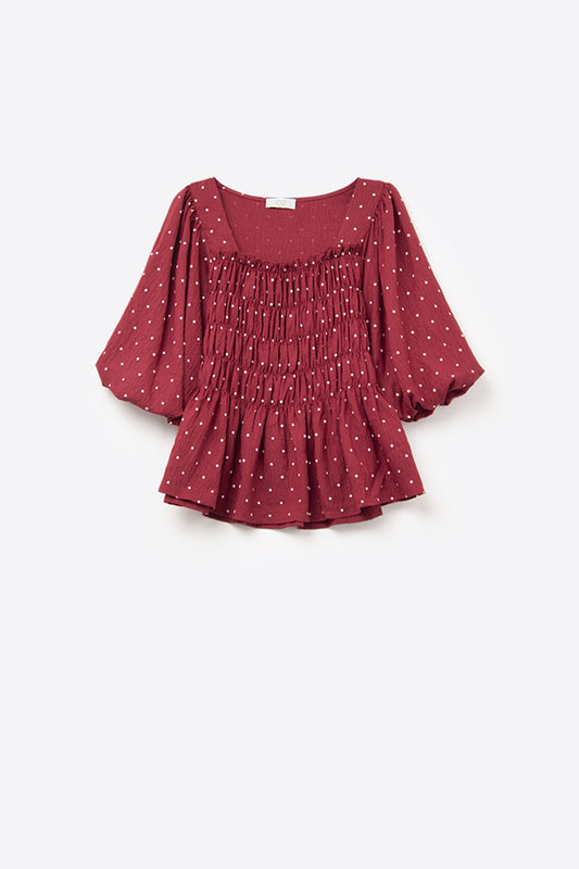 Top chic rosso a pois aderente in vita