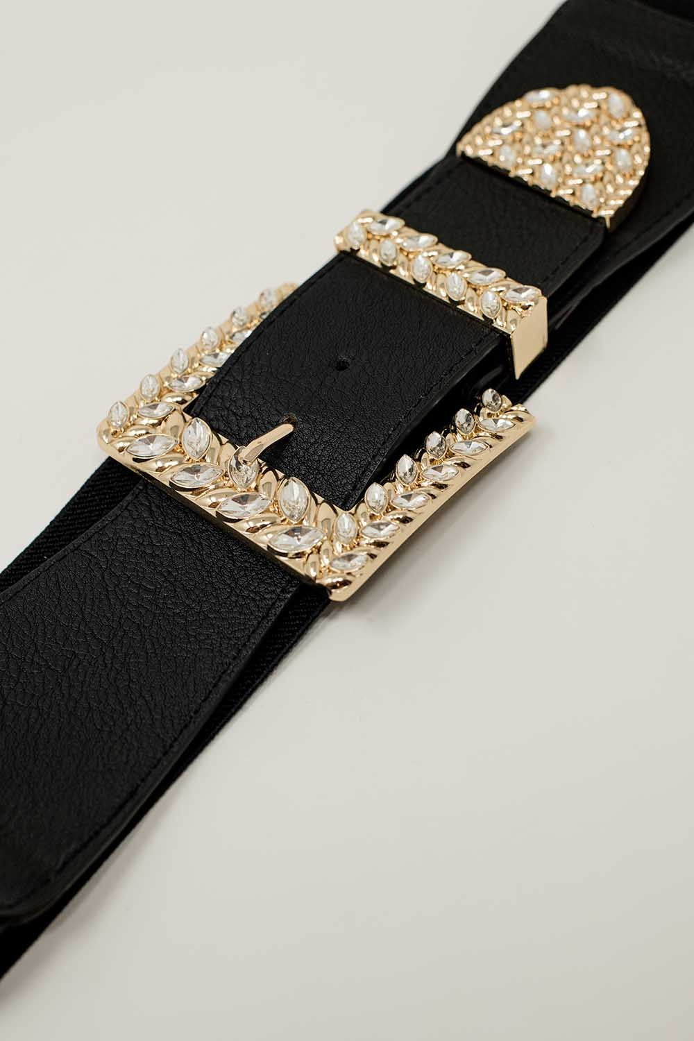 Cintura nera elastica con fibbia e punta in metallo con strass.