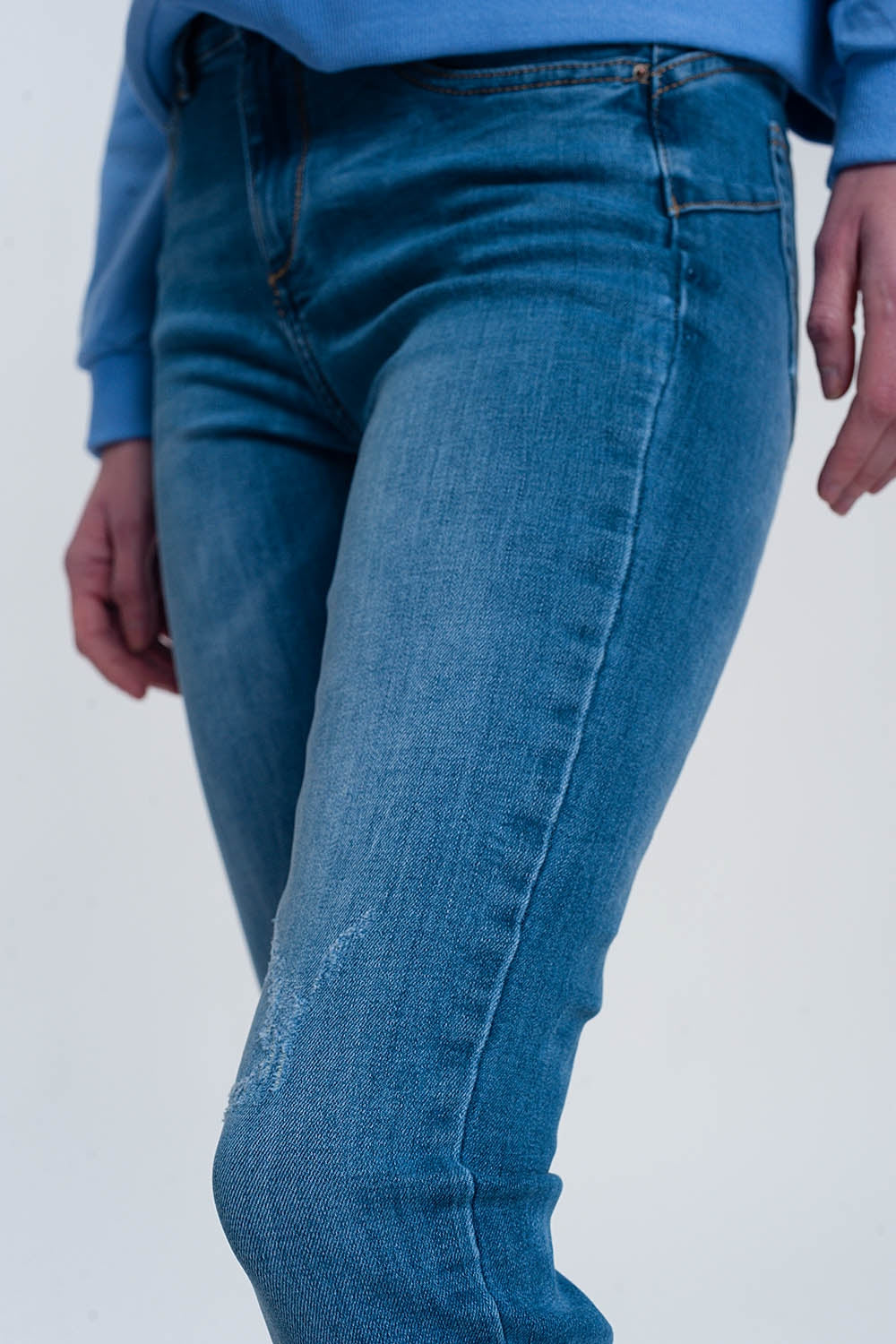 jeans skinny in denim chiaro con caviglie piegate e dettaglio strappato